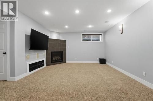 83 Kirton Close, Red Deer, AB - Indoor Photo Showing Basement With Fireplace