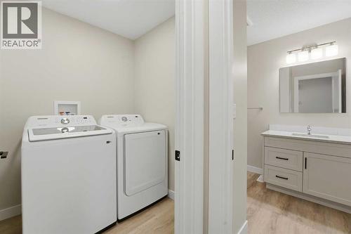 Laundry area on the main level - 82 Bruns Crescent, Lacombe, AB - Indoor Photo Showing Laundry Room
