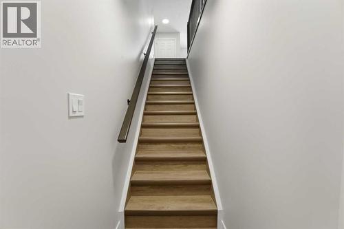 Stairs to basement level - 82 Bruns Crescent, Lacombe, AB - Indoor Photo Showing Other Room