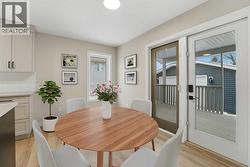 The dining area overlooks the backyard and deck through patio doors - 