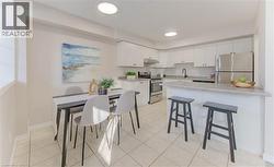 The dining area and kitchen are open and bright, making cooking and sharing meals easy. - 