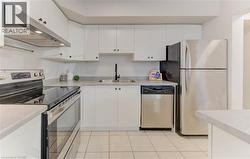 Updated kitchen counters, brand new stove, and stainless steel appliances with breakfast bar & loads of storage - 