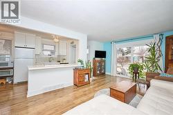 Living room with healthy amount of natural light and light wood-style floors - 
