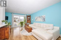 Living room with light wood-style flooring - 