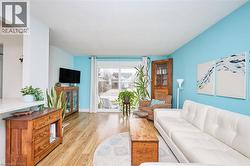 Living room featuring wood-type flooring and baseboards - 