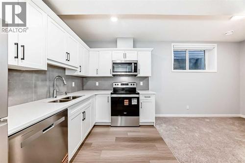 32 Creekview Common Sw, Calgary, AB - Indoor Photo Showing Kitchen With Stainless Steel Kitchen With Double Sink