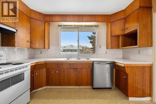 2719 Chalice Road Nw, Calgary, AB - Indoor Photo Showing Kitchen With Double Sink