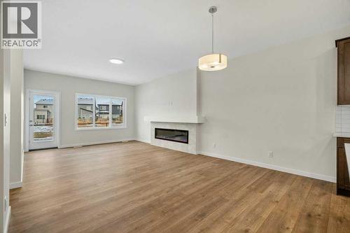 136 Wolf Hollow Manor Se, Calgary, AB - Indoor Photo Showing Living Room With Fireplace