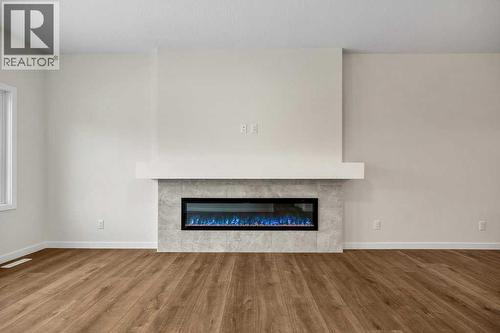 136 Wolf Hollow Manor Se, Calgary, AB - Indoor Photo Showing Living Room With Fireplace