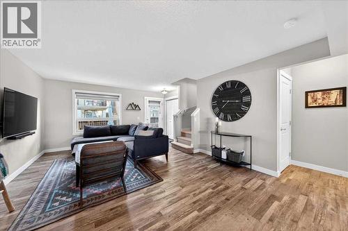 Main floor living area with convenient main floor half bath - 37 Aspen Hills Terrace Sw, Calgary, AB - Indoor Photo Showing Living Room