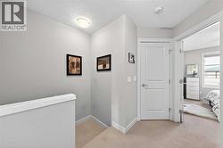 Upper-level hallway with laundry room access - 
