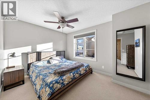 Primary bedroom with ceiling fan and abundant natural light - 37 Aspen Hills Terrace Sw, Calgary, AB - Indoor Photo Showing Bedroom