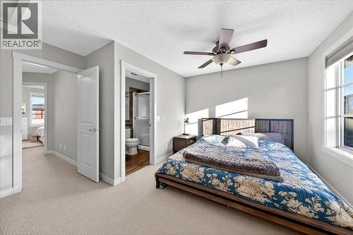 Primary bedroom with private ensuite access - 37 Aspen Hills Terrace Sw, Calgary, AB - Indoor Photo Showing Bedroom