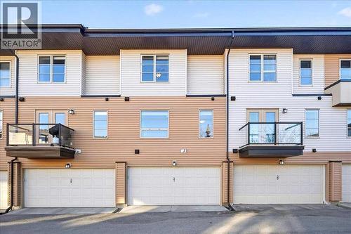 Rear exterior with double attached garage door - 37 Aspen Hills Terrace Sw, Calgary, AB - Outdoor With Exterior