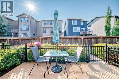 Patio shown in summer. A private outdoor space for morning coffee and quiet evenings - 37 Aspen Hills Terrace Sw, Calgary, AB - Outdoor