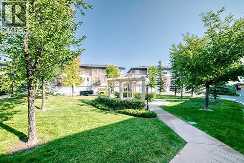 Summer view of the courtyard. Pergola, park benches, and a peaceful place to step outside - 37 Aspen Hills Terrace Sw, Calgary, AB - Outdoor
