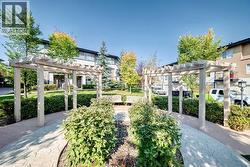 Photographed in summer months. Landscaped greenspace with paths and seating woven throughout - 