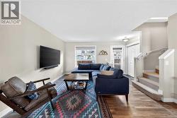 Living room with front entry and stairway to upper level - 