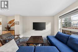 Living room with large window and central TV wall - 