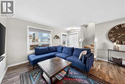 Living room with clear sightlines to the entry and stairwell - 