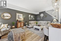 Living area with baseboards and wood finished floors - 