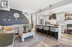 Living area featuring light wood-style floors and recessed lighting - 