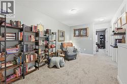 Sitting room featuring light carpet and baseboards - 