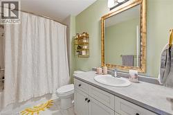 Bathroom with vanity and shower / bath combo with shower curtain - 