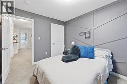 Bedroom featuring light colored carpet and baseboards - 