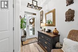 Foyer entrance featuring light wood-style floors and a chandelier - 