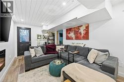 Living room featuring wood finished floors, wood ceiling, and recessed lighting - 