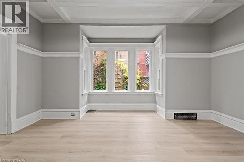 Spare room with light wood-style flooring and coffered ceiling - 88 Gage Avenue S, Hamilton, ON - Indoor