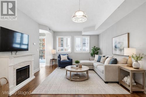 VIRTUALLY STAGED - 610 - 399 Elizabeth Street, Burlington, ON - Indoor Photo Showing Living Room With Fireplace