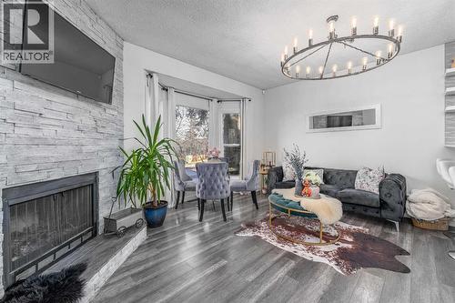 1347 Berkley Drive Nw, Calgary, AB - Indoor Photo Showing Living Room With Fireplace