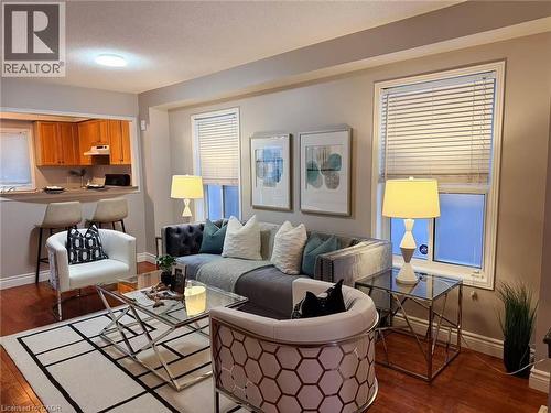 Living room featuring dark wood-style floors and a textured ceiling - 2258 Empire Crescent, Burlington, ON - Indoor Photo Showing Living Room