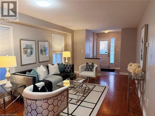 Living area featuring dark wood finished floors and a textured ceiling - 2258 Empire Crescent, Burlington, ON - Indoor Photo Showing Living Room