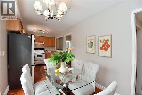 Dining space with hardwood / wood-style floors and a chandelier - 2258 Empire Crescent, Burlington, ON - Indoor Photo Showing Dining Room