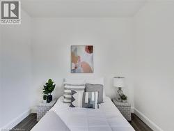 Bedroom featuring baseboards and wood finished floors - 