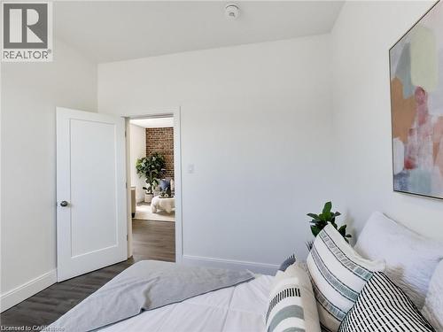 Bedroom with baseboards and dark wood-style flooring - 54 Fairview Avenue, Hamilton, ON - Indoor Photo Showing Bedroom