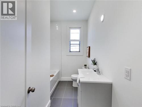 Bathroom with tile patterned floors, vanity, toilet, and baseboards - 54 Fairview Avenue, Hamilton, ON - Indoor Photo Showing Bathroom