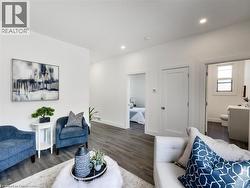 Living area with baseboards, wood finished floors, and recessed lighting - 
