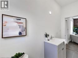 Bathroom with vanity and wood finished floors - 