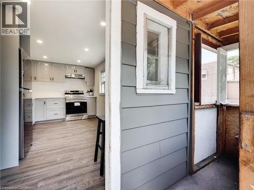 Kitchen featuring light countertops, wood finished floors, appliances with stainless steel finishes, under cabinet range hood, and recessed lighting - 54 Fairview Avenue, Hamilton, ON - Indoor
