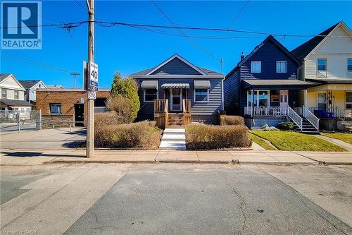 View of front of house featuring covered porch and fence - 54 Fairview Avenue, Hamilton, ON - Outdoor With Facade