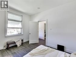 Bedroom featuring baseboards and wood finished floors - 