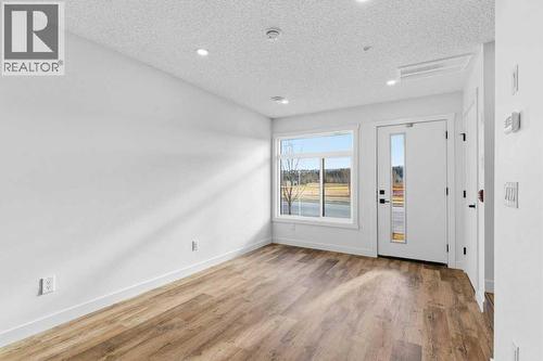 102, 156 Park Street, Cochrane, AB - Indoor Photo Showing Other Room