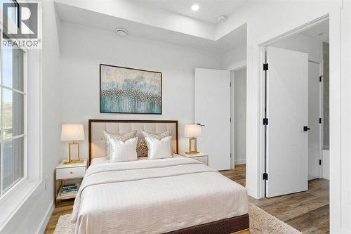 102, 156 Park Street, Cochrane, AB - Indoor Photo Showing Bedroom