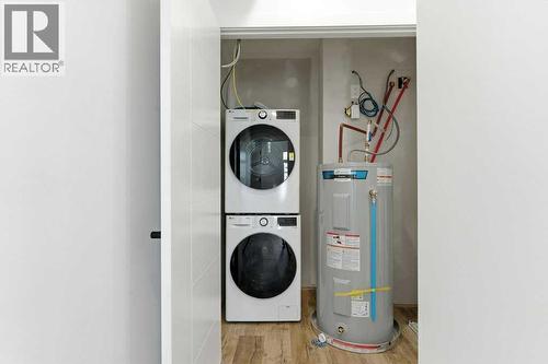102, 156 Park Street, Cochrane, AB - Indoor Photo Showing Laundry Room