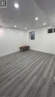 Finished basement with wood finished floors and recessed lighting - 