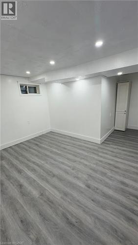 Finished below grade area featuring wood finished floors and recessed lighting - 18 Ingleside Drive, Kitchener, ON - Indoor